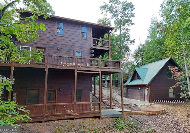 rear view of house with a wooden deck