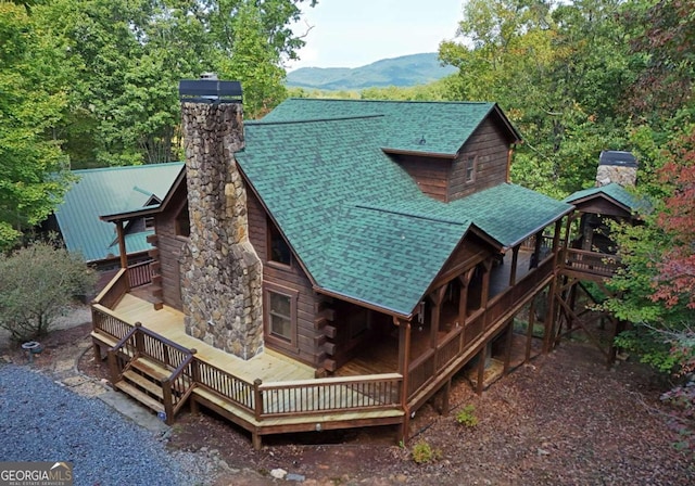 exterior space featuring a deck with mountain view