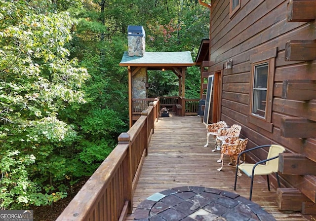 wooden terrace featuring a gazebo