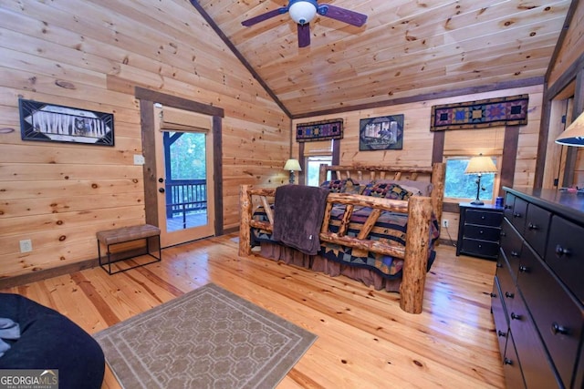 bedroom featuring wooden walls, wood ceiling, light hardwood / wood-style floors, and lofted ceiling