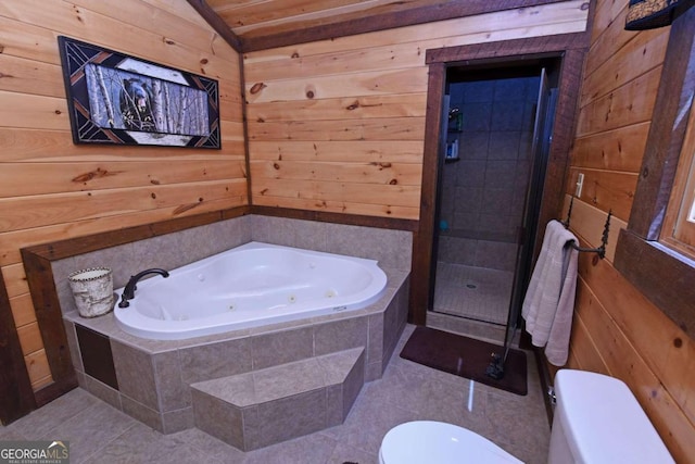 bathroom featuring wood walls, toilet, plus walk in shower, and tile patterned floors