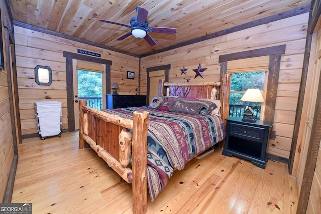 bedroom with wood ceiling, wood walls, ceiling fan, and light hardwood / wood-style flooring