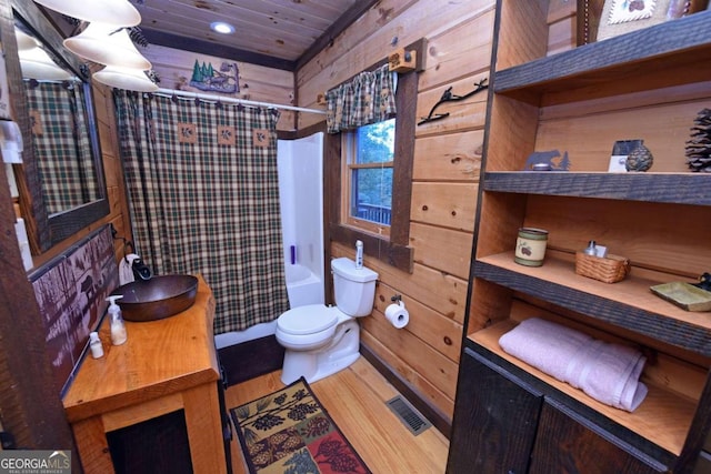 full bathroom featuring wood ceiling, wood walls, shower / bath combo with shower curtain, hardwood / wood-style flooring, and toilet