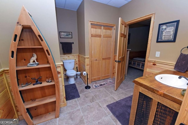 bathroom featuring sink, tile patterned floors, and toilet