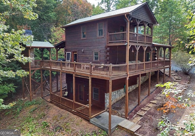 back of property featuring a wooden deck