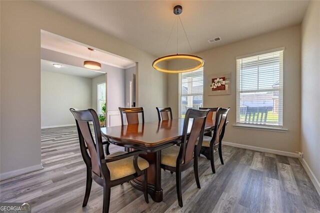 dining space with hardwood / wood-style floors