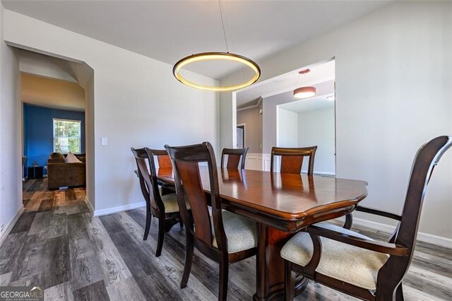 dining space with dark wood-type flooring