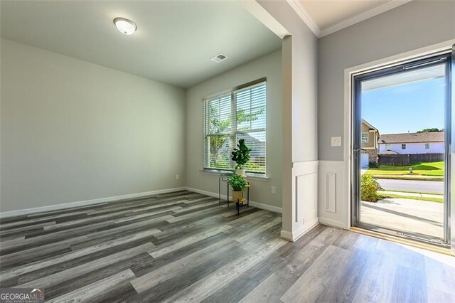 entrance foyer with crown molding and hardwood / wood-style floors