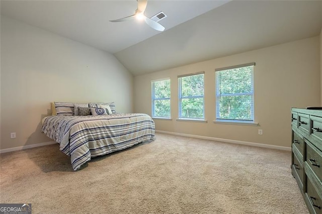 carpeted bedroom featuring vaulted ceiling and ceiling fan