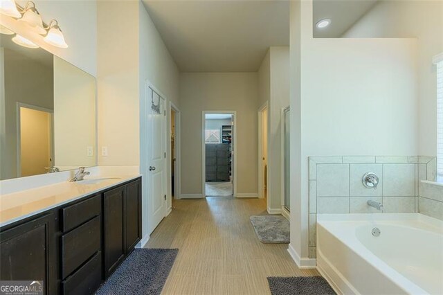 bathroom featuring vanity and plus walk in shower