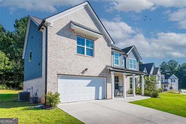 view of front of home featuring cooling unit, a front yard, and a garage