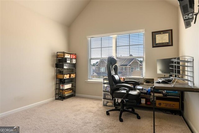 office space featuring high vaulted ceiling and light colored carpet