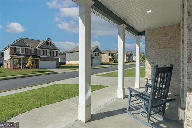 view of patio / terrace featuring a garage and covered porch