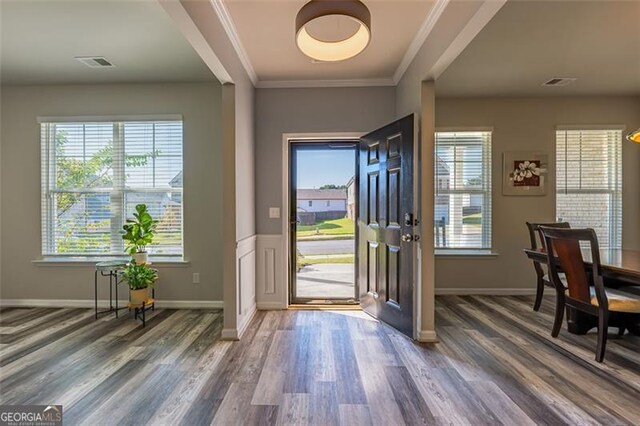 foyer featuring crown molding and dark wood-type flooring