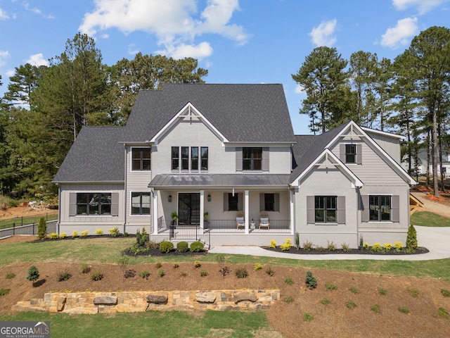 modern farmhouse featuring a front yard and a porch