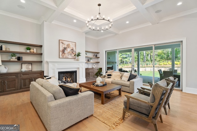 living room featuring coffered ceiling, beamed ceiling, light hardwood / wood-style floors, and a chandelier