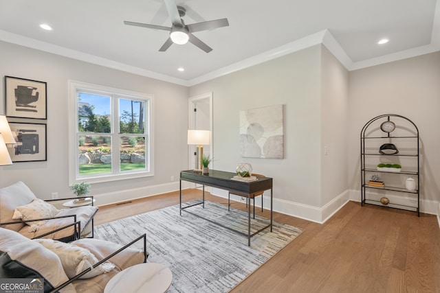 office space featuring ornamental molding, ceiling fan, and hardwood / wood-style flooring