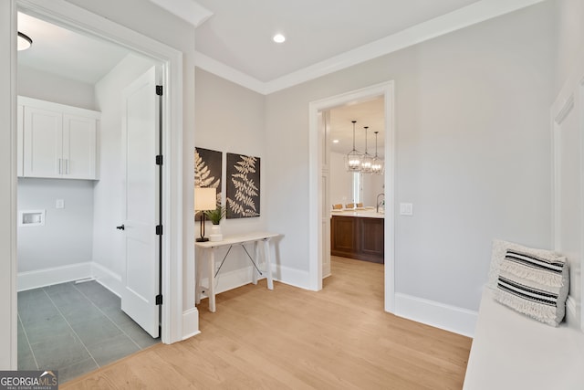 hallway featuring a notable chandelier and light hardwood / wood-style floors