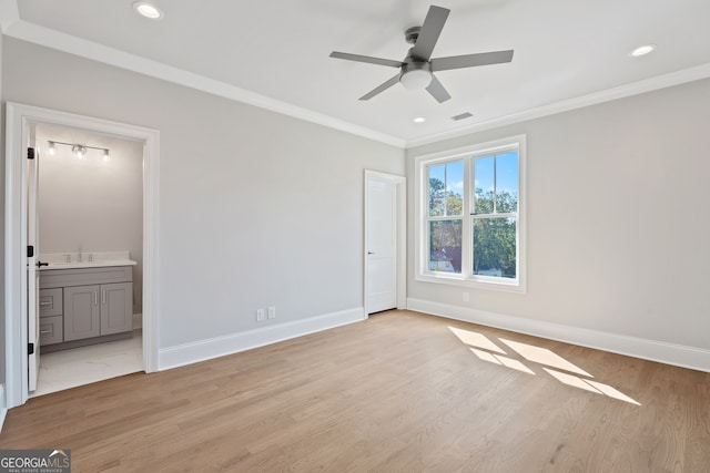 unfurnished bedroom featuring crown molding, ceiling fan, light hardwood / wood-style flooring, ensuite bathroom, and sink