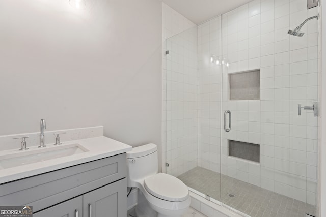 bathroom featuring walk in shower, vanity, and toilet