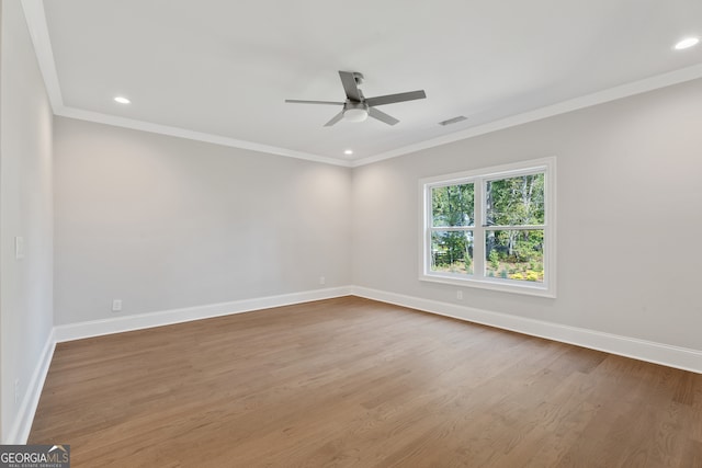 unfurnished room with ceiling fan, ornamental molding, and hardwood / wood-style floors