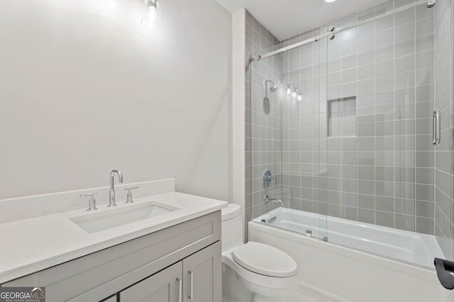 full bathroom featuring enclosed tub / shower combo, vanity, and toilet