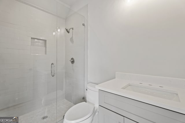 bathroom featuring walk in shower, vanity, and toilet