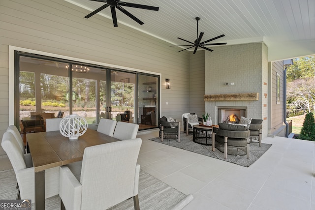 view of patio / terrace featuring an outdoor living space with a fireplace and ceiling fan