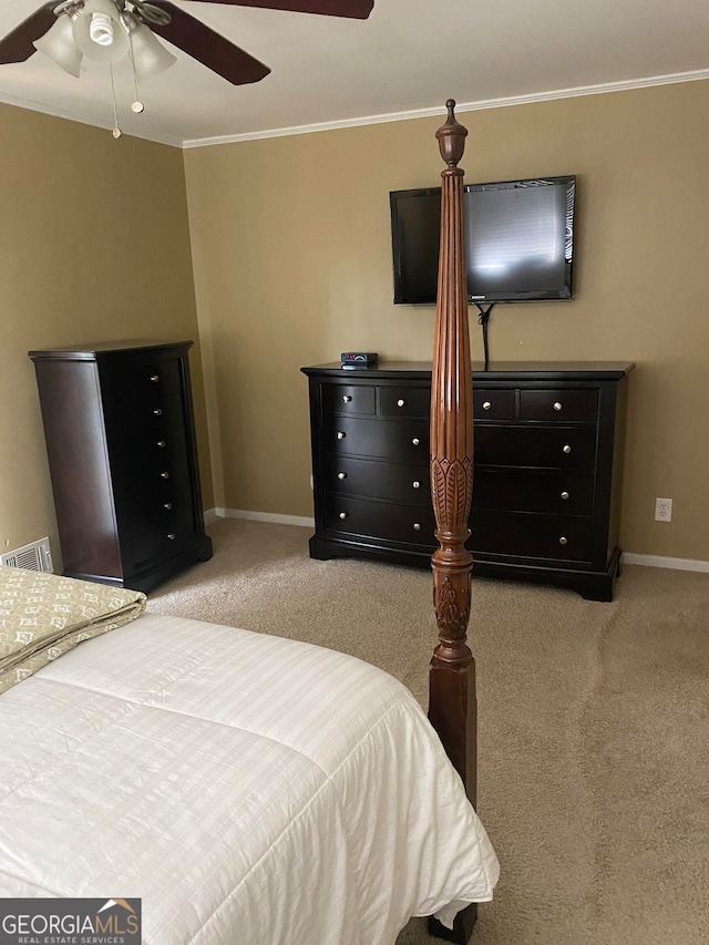 carpeted bedroom with ceiling fan and ornamental molding