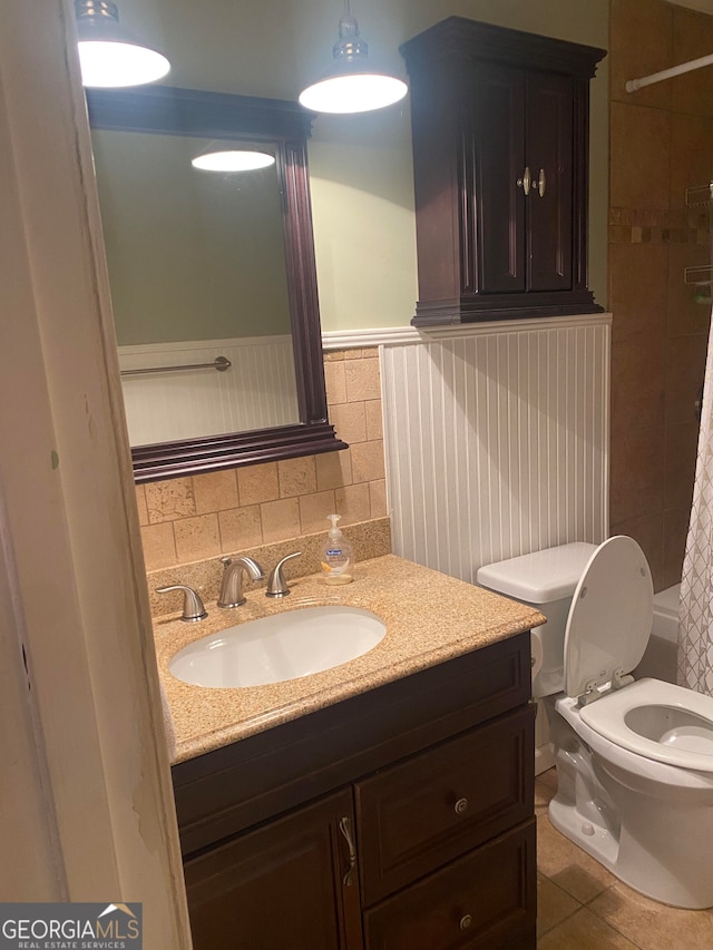 bathroom with toilet, vanity, tile patterned floors, and walk in shower