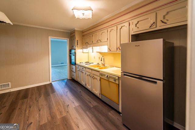 kitchen with dark wood-type flooring, stainless steel appliances, crown molding, and sink