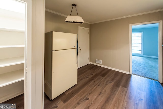 kitchen featuring crown molding, dark hardwood / wood-style flooring, and white refrigerator