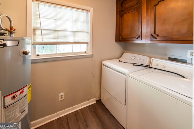 clothes washing area featuring washer and clothes dryer, dark hardwood / wood-style flooring, cabinets, and water heater