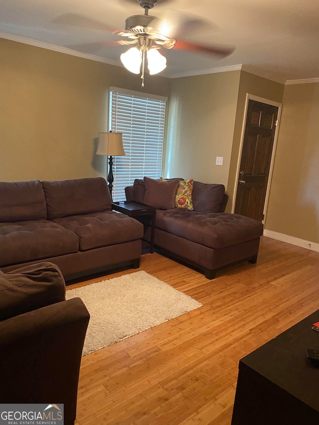 living room with hardwood / wood-style flooring, ceiling fan, and crown molding