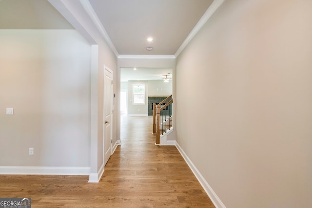 hall featuring light wood-type flooring and ornamental molding