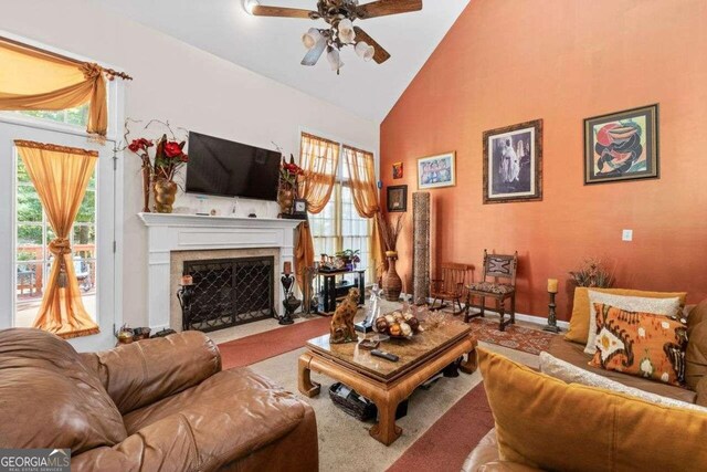 living room featuring ceiling fan and high vaulted ceiling