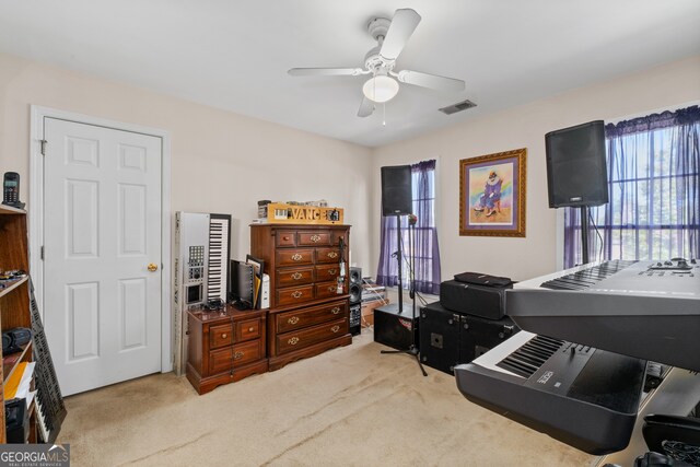 misc room with ceiling fan and light colored carpet