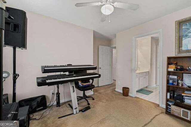 misc room featuring ceiling fan and light colored carpet