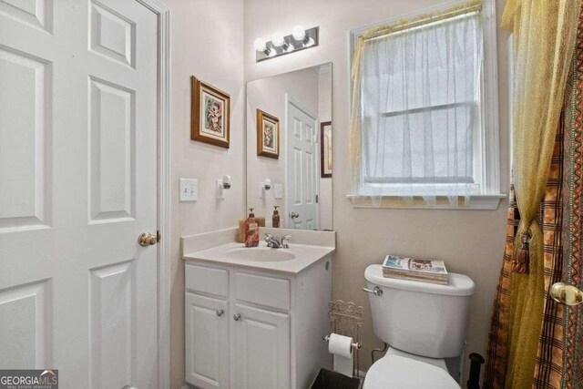 bathroom featuring vanity and toilet