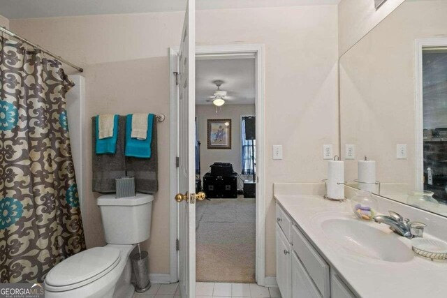 bathroom featuring tile patterned flooring, vanity, toilet, and ceiling fan