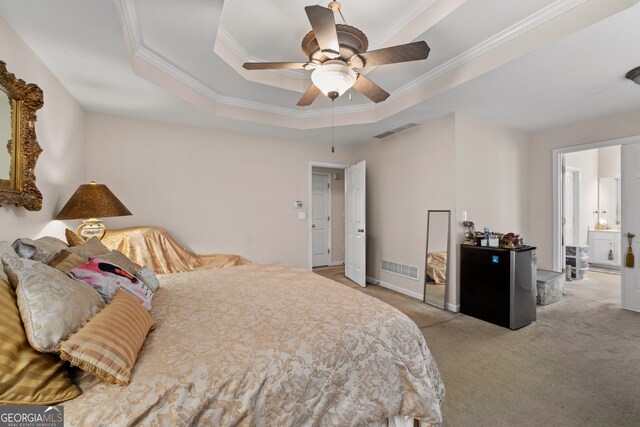 bedroom featuring light carpet, a raised ceiling, ceiling fan, stainless steel fridge, and ornamental molding