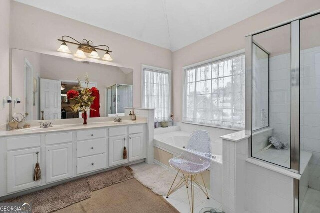 bathroom featuring vanity and shower with separate bathtub