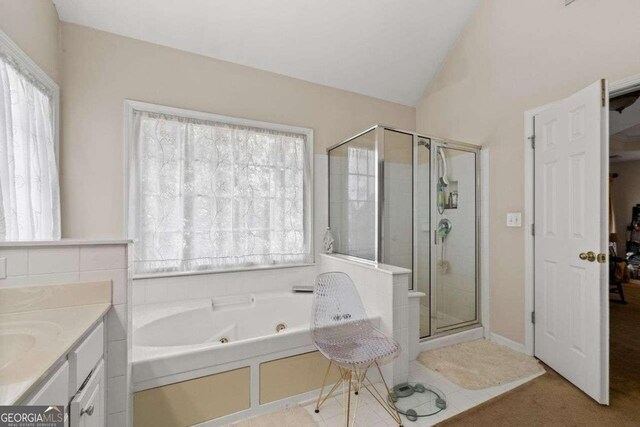 bathroom featuring plenty of natural light, lofted ceiling, and plus walk in shower