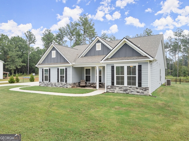 craftsman inspired home with a front lawn, central AC unit, and a patio area