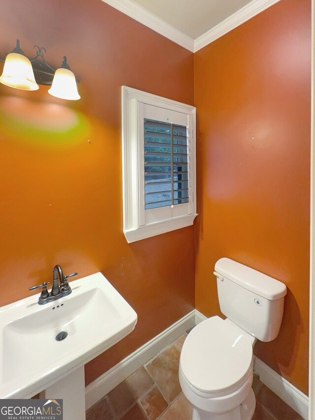 bathroom featuring ornamental molding, sink, and toilet