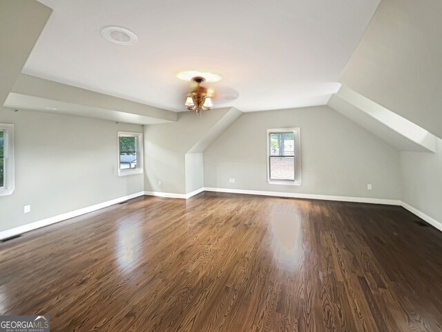 bonus room featuring ceiling fan, dark hardwood / wood-style floors, and lofted ceiling with skylight