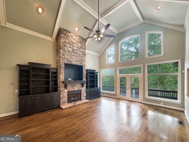 unfurnished living room with ceiling fan, french doors, wood-type flooring, high vaulted ceiling, and a fireplace