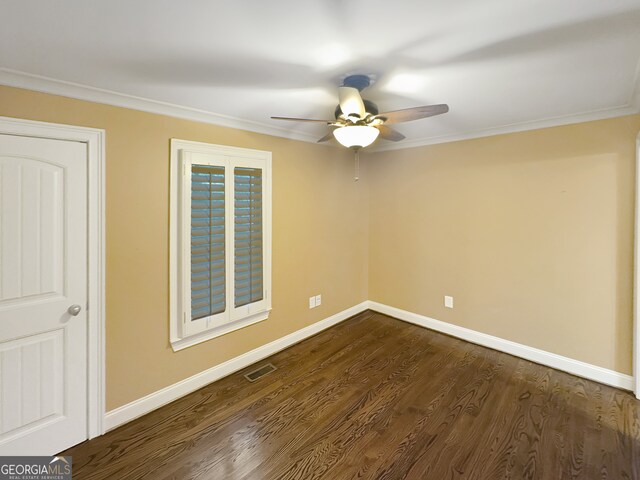 unfurnished room featuring ornamental molding, ceiling fan, and dark wood-type flooring