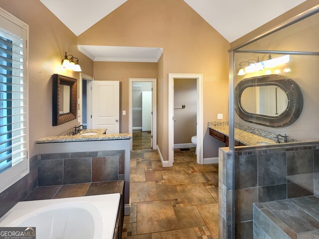 bathroom with vaulted ceiling, a relaxing tiled tub, crown molding, vanity, and toilet