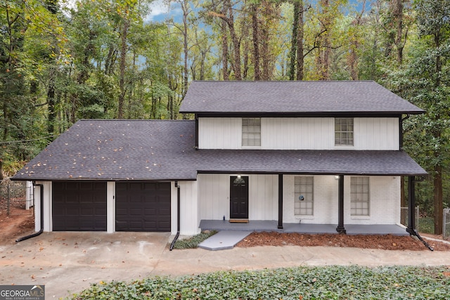 front of property featuring covered porch and a garage